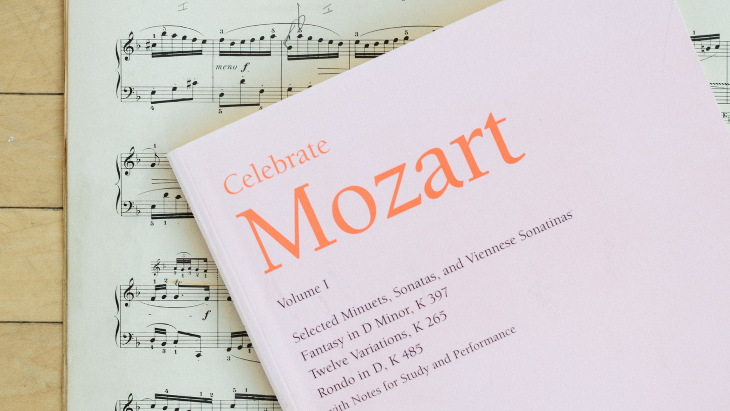 Book titled 'Celebrate Mozart' on sheet music